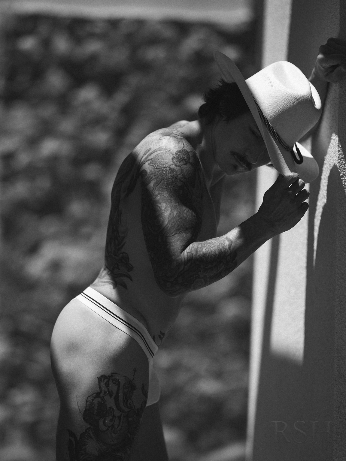 Andy Mendoza in a cowboy hat, photographed in black and white